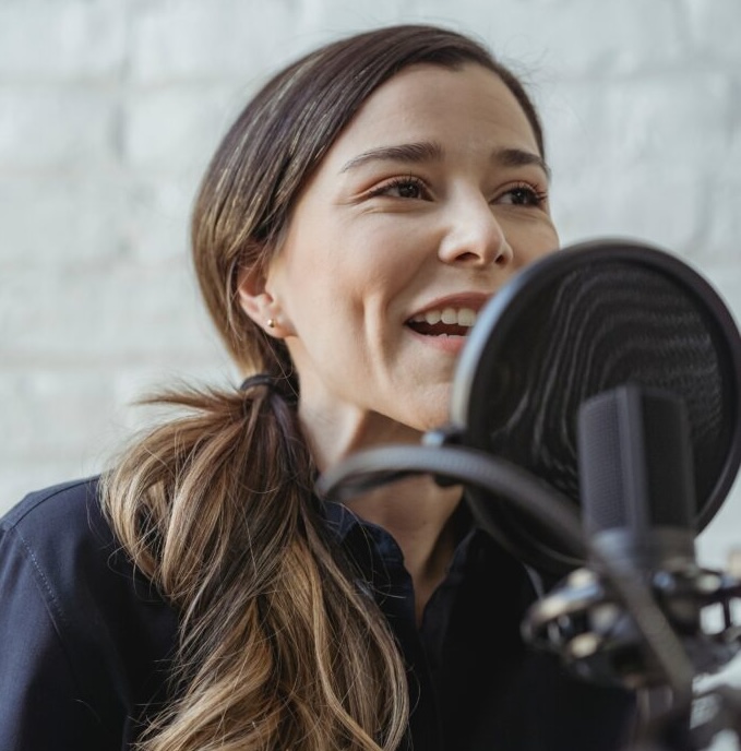pexels-george-milton-6953675-683x1024 Image of a women speaking into a microphone